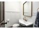 Charming bathroom with white wainscoting, a vintage sink, and a gold framed mirror at 3356 N Park Ave, Indianapolis, IN 46205