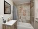 Bathroom with decorative tile surrounding tub, decorative mirror, and newer vanity at 3356 N Park Ave, Indianapolis, IN 46205