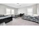 Bright bedroom with three twin beds, white walls, two windows, and neutral carpet at 3356 N Park Ave, Indianapolis, IN 46205