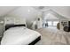 Attic bedroom with a slanted ceiling, a bed, and an adjacent sitting area at 3356 N Park Ave, Indianapolis, IN 46205