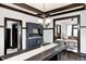 A formal dining room shows dark wood trim, built in hutch, with a rustic table and chandelier at 3356 N Park Ave, Indianapolis, IN 46205