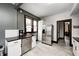 Kitchen with stainless steel appliances, white cabinetry, dark countertops, and tiled floors at 3356 N Park Ave, Indianapolis, IN 46205