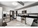 Spacious kitchen featuring stainless steel appliances, white cabinets, and black countertops at 3356 N Park Ave, Indianapolis, IN 46205