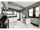 Bright kitchen with gray walls, white cabinets, stainless steel appliances, and a large window at 3356 N Park Ave, Indianapolis, IN 46205