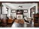 Comfortable living room with fireplace, leather sofa, and views into other rooms at 3356 N Park Ave, Indianapolis, IN 46205
