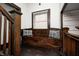 Cozy window bench with pillows at the top of an enclosed dark wood staircase at 3356 N Park Ave, Indianapolis, IN 46205