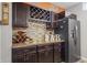 Basement wet bar featuring custom cabinetry, wine storage, and a stainless steel refrigerator at 377 Morningside Dr, Brownsburg, IN 46112