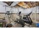 Unfinished basement area with gym equipment including elliptical, treadmill and bike trainer at 377 Morningside Dr, Brownsburg, IN 46112