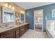 This bathroom features a double sink, decorative wood wall, and is stylishly decorated at 377 Morningside Dr, Brownsburg, IN 46112