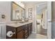 Bathroom featuring a double vanity, granite countertops, and decorative wall accents at 377 Morningside Dr, Brownsburg, IN 46112