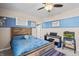Comfortable bedroom designed with blue striped accent wall, plush bed, and a ceiling fan at 377 Morningside Dr, Brownsburg, IN 46112