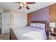 Bedroom featuring wood and purple accent wall and bright ceiling fan at 377 Morningside Dr, Brownsburg, IN 46112