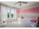 Bright bedroom featuring a daybed, ceiling fan, and personalized wall decor at 377 Morningside Dr, Brownsburg, IN 46112