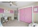 Bedroom with a desk, closet with pink doors, and neutral carpet at 377 Morningside Dr, Brownsburg, IN 46112