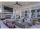 Relaxing covered patio with an outdoor fireplace, TV, ceiling fan, and plush seating for enjoying outdoor living at 377 Morningside Dr, Brownsburg, IN 46112
