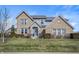 Charming two-story home with brick and stone accents, a manicured lawn, and a welcoming blue front door at 377 Morningside Dr, Brownsburg, IN 46112