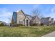 Two-story home with brick and stone accents, a manicured lawn, and a mature tree at 377 Morningside Dr, Brownsburg, IN 46112