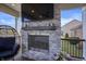 Outdoor stone fireplace with mounted TV and egg chair to add a cozy touch to any outdoor space at 377 Morningside Dr, Brownsburg, IN 46112