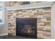 Close up on a modern fireplace with a decorative stone surround and white mantle at 377 Morningside Dr, Brownsburg, IN 46112