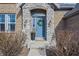 Charming front entrance with stone accents, a wreath, and a vibrant flower arrangement at 377 Morningside Dr, Brownsburg, IN 46112