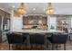 Modern kitchen features a large island with seating, pendant lighting, and stainless steel appliances at 377 Morningside Dr, Brownsburg, IN 46112
