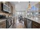 Modern kitchen features stainless steel appliances, wooden cabinets, and dark hardwood floors at 377 Morningside Dr, Brownsburg, IN 46112