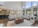 Bright living room features tall windows, neutral furnishings, and flows into the modern kitchen at 377 Morningside Dr, Brownsburg, IN 46112