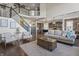 Spacious living room with a staircase, view of the kitchen, and comfortable seating at 377 Morningside Dr, Brownsburg, IN 46112