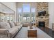 Cozy living room features a stone fireplace, large windows, and comfortable seating at 377 Morningside Dr, Brownsburg, IN 46112