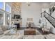 Open-concept living room featuring a stone fireplace, plush seating, and staircase at 377 Morningside Dr, Brownsburg, IN 46112