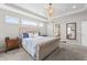 Bright main bedroom with a luxurious bed, carpet floors, and a view of the ensuite at 377 Morningside Dr, Brownsburg, IN 46112