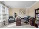 Well-lit home office with built-in bookshelves, a comfortable chair, and a large window at 377 Morningside Dr, Brownsburg, IN 46112