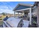 Backyard space showcasing an outdoor kitchen, covered patio with a fireplace, and seating area overlooking the water at 377 Morningside Dr, Brownsburg, IN 46112