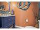 Stylish powder room featuring a blue vanity, modern fixtures, and decorative wall accents at 377 Morningside Dr, Brownsburg, IN 46112