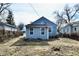 Backyard with trees and a patchy grass lawn surrounded by a wooden fence at 3910 E 34Th St, Indianapolis, IN 46218