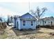 Backyard with trees and a patchy grass lawn surrounded by a wooden fence at 3910 E 34Th St, Indianapolis, IN 46218