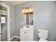 This bathroom boasts bright lighting and a modern vanity with commode and easy access to the rest of the home at 3910 E 34Th St, Indianapolis, IN 46218