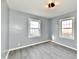 Charming bedroom featuring gray walls, modern lighting and lots of natural light from the two windows at 3910 E 34Th St, Indianapolis, IN 46218