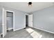 This bright bedroom features a neutral gray paint, wood-look flooring, and easy closet access at 3910 E 34Th St, Indianapolis, IN 46218