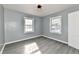 This cozy bedroom features sleek gray floors, neutral walls and bright, natural light from two windows at 3910 E 34Th St, Indianapolis, IN 46218