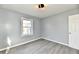 Cozy bedroom with natural light, wood-look floors, and simple but modern ceiling light fixture at 3910 E 34Th St, Indianapolis, IN 46218