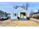 Charming light blue house with a bright yellow door, gray trim, and a small front yard at 3910 E 34Th St, Indianapolis, IN 46218
