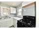 Updated kitchen with white cabinets, marbled countertops, stainless steel sink and black gas range at 3910 E 34Th St, Indianapolis, IN 46218
