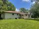 Expansive backyard featuring a white brick house, patio, and lots of green grass at 5324 Mann Rd, Indianapolis, IN 46221