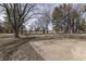 Spacious backyard with mature trees and a concrete patio at 5324 Mann Rd, Indianapolis, IN 46221