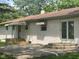 Back exterior of the house with a patio, awning-covered porch, and French doors at 5324 Mann Rd, Indianapolis, IN 46221