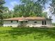 Spacious backyard featuring lush greenery and a well-maintained lawn behind the home at 5324 Mann Rd, Indianapolis, IN 46221