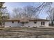 Rear view of a charming ranch home with a patio and large yard at 5324 Mann Rd, Indianapolis, IN 46221
