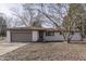 Newly painted brick ranch home with a brown roof, attached garage, and landscaping at 5324 Mann Rd, Indianapolis, IN 46221