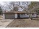 Newly painted white brick ranch home with brown roof and attached garage at 5324 Mann Rd, Indianapolis, IN 46221